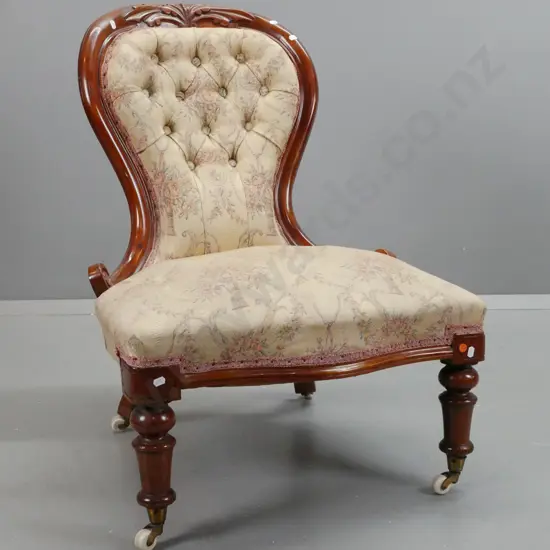 Victorian walnut lady's chair with shaped front, turned front legs on porcelain cupped casters, floral upholstered seat
