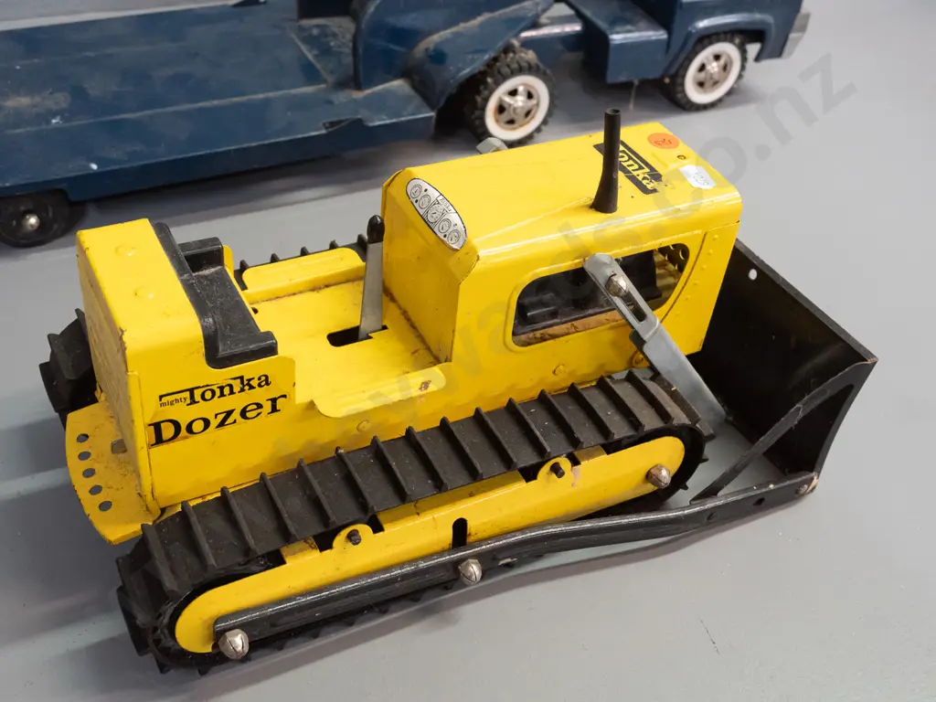 2 Tonka steel toy vehicles - Mighty Tonka dozer and a blue cab w/ flatbed trailer - Tonka New Zealand stickers on door Image 1++