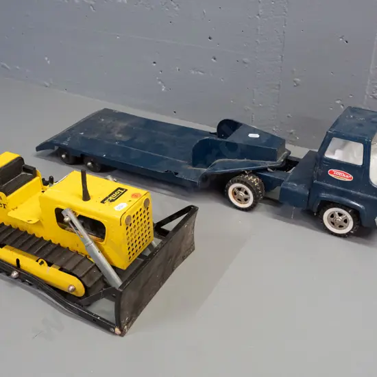 2 Tonka steel toy vehicles - Mighty Tonka dozer and a blue cab w/ flatbed trailer - Tonka New Zealand stickers on door