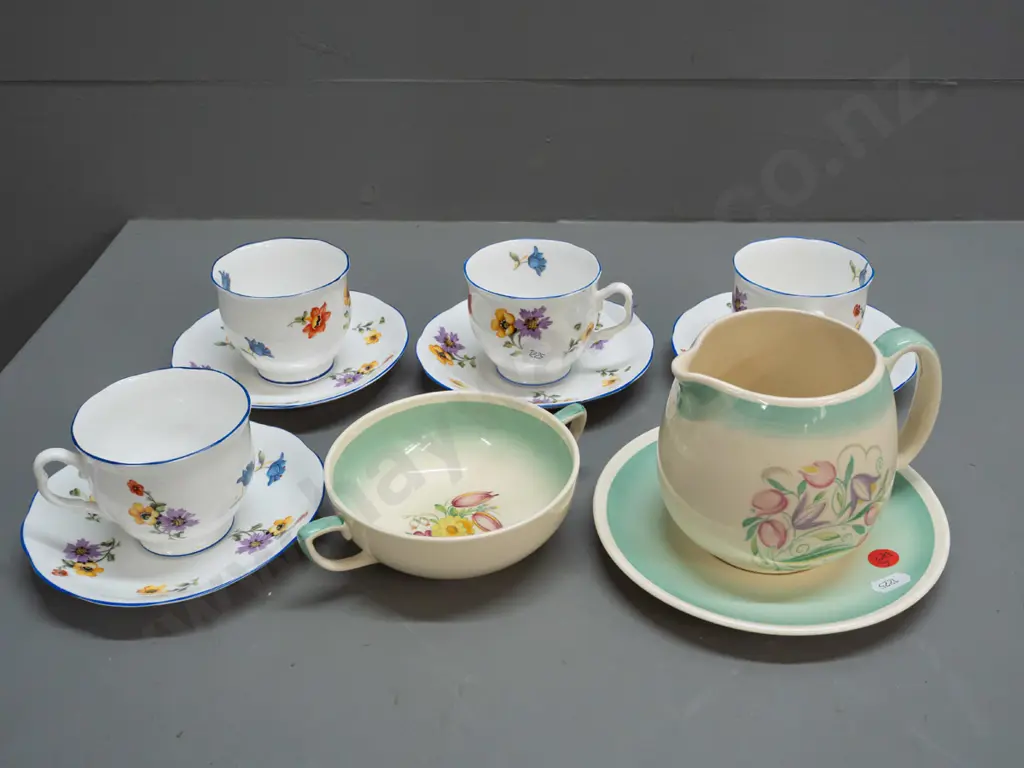 3 pieces Susie Cooper and 4 vintage Royal Albert cups & saucers with floral decoration and blue rims. Susie Cooper jug Image 1++