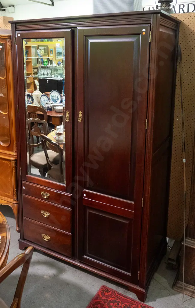 reproduction mahogany wardrobe in the style of a linen press with 2 doors, 1 w/bevelled edge mirror, 3 drawers, brass Image 1++