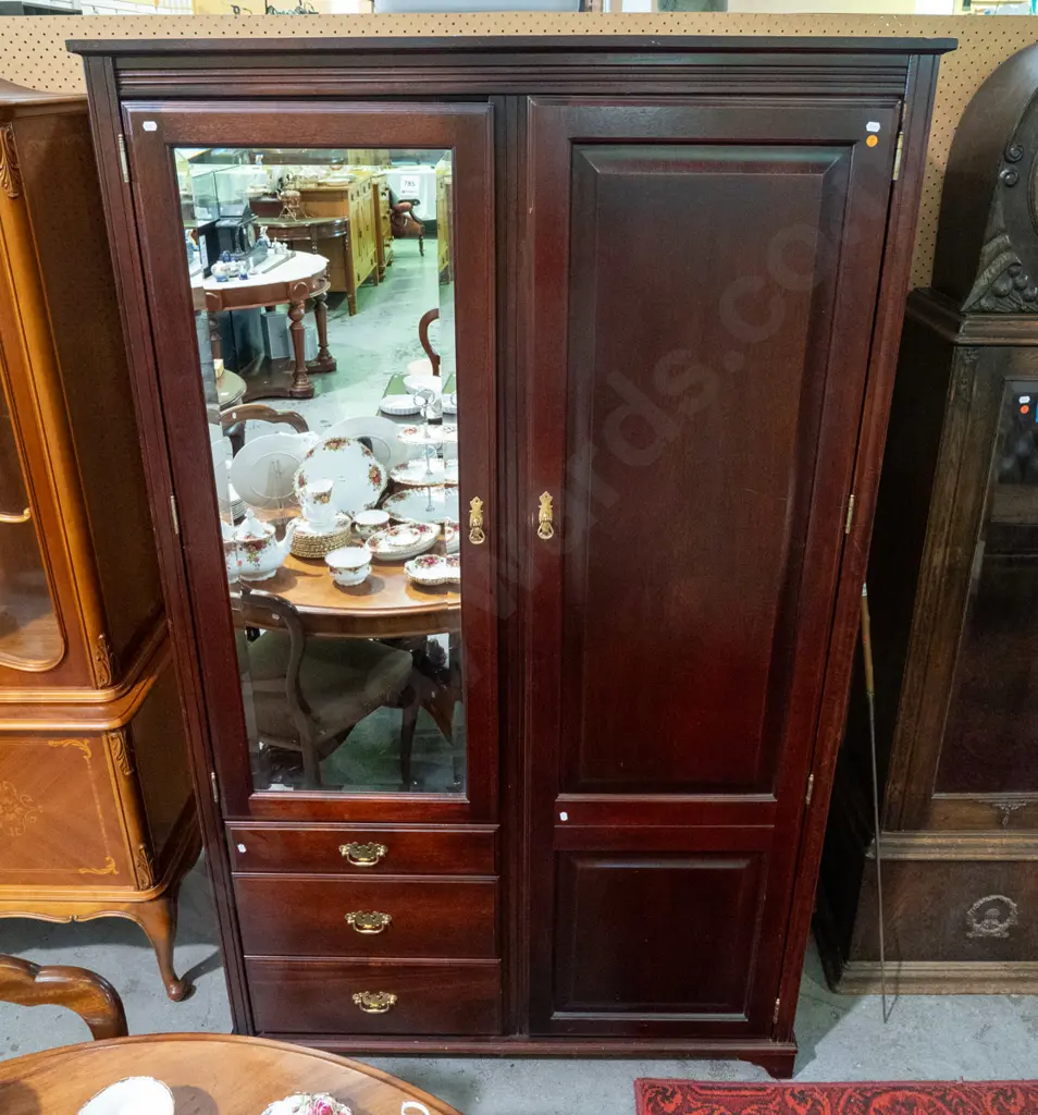 reproduction mahogany wardrobe in the style of a linen press with 2 doors, 1 w/bevelled edge mirror, 3 drawers, brass Image 1++
