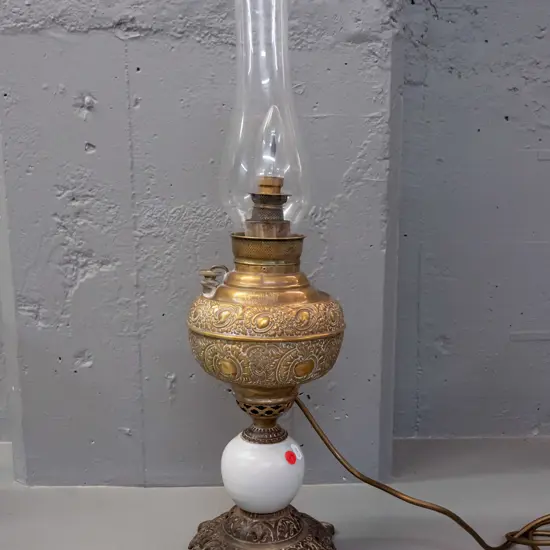vintage Miller USA kerosene lamp with cast metal and ceramic base, converted to electric bulb, glass chimney sits loose