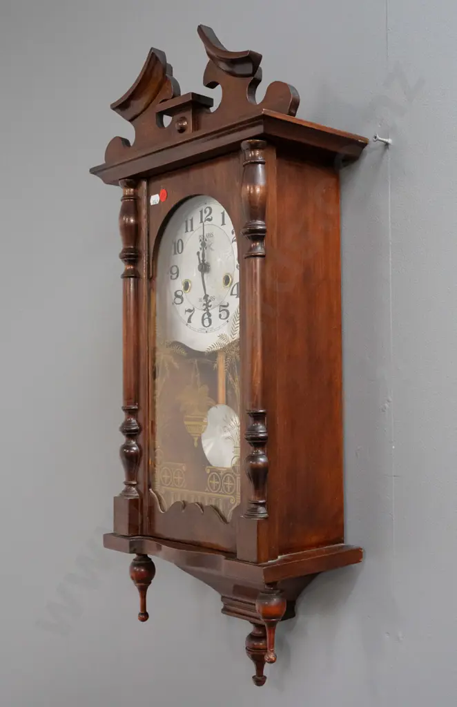 reproduction Polaris wall clock in walnut cabinet with gilt-decorated glazed door, half-turned supports, bottom finials Image 1++