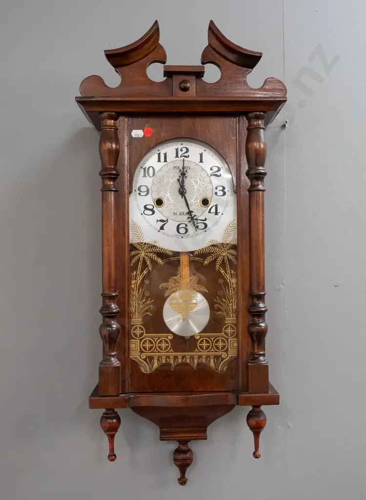 reproduction Polaris wall clock in walnut cabinet with gilt-decorated glazed door, half-turned supports, bottom finials Image 1++