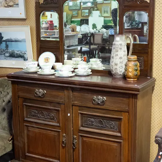 Edwardian mahogany mirror-back sideboard with carved panels in top w/ 3 arched beveled edge mirrors, 2 panelled doors