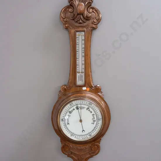 vintage oak-cased wall barometer-thermometer with porcelain faces & mercury filled thermometer in foliate carved case.