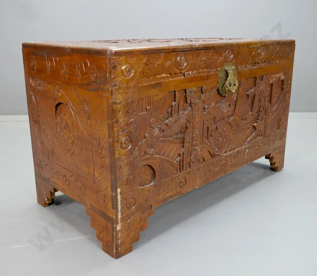 Chinese camphorwood chest with profusely carved scenic panels, tray inside, brass split-key lock, scallop shape Image 1++