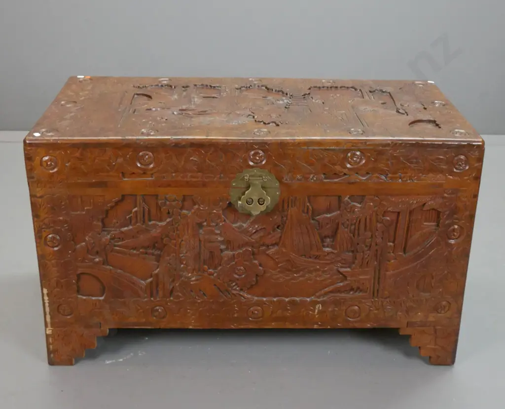 Chinese camphorwood chest with profusely carved scenic panels, tray inside, brass split-key lock, scallop shape Image 1++