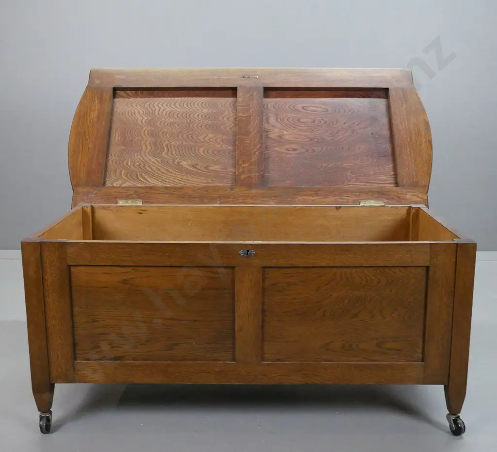 Art deco oak blanket box, with upholstered top, 2 panel front on castors, lock is broken Image 1++