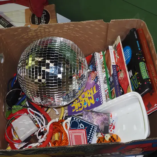 box; magic books, disco ball, playing cards, dice etc