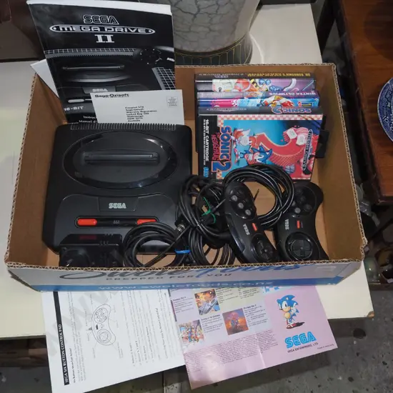 box: Sega Mega Drive II with controllers and games