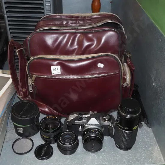 Pentax ME Super 35mm camera with small tripod, 3 additional lenses, vinyl bag and accessories