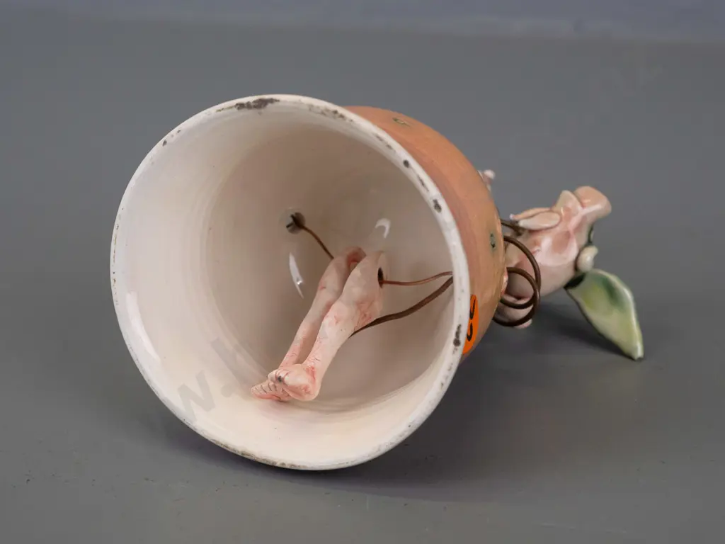 Marion Mewburn - ceramic figurine in the form of a bell w/ legs suspended inside dress, with flying pig attached on wire Image 1++