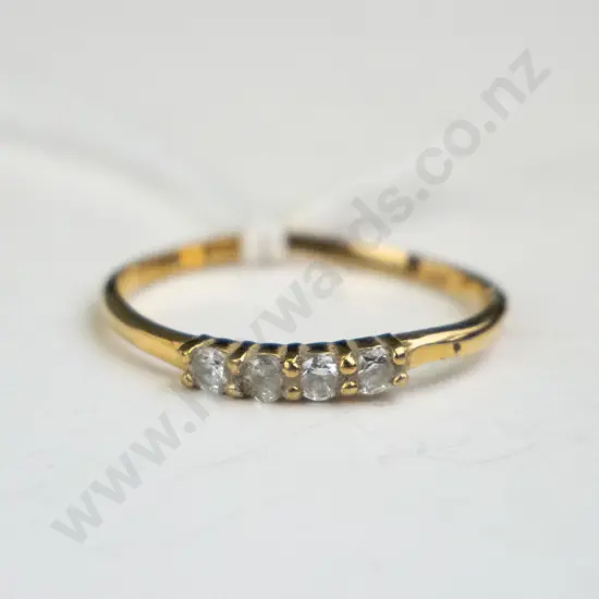 Gold ring with four diamonds.