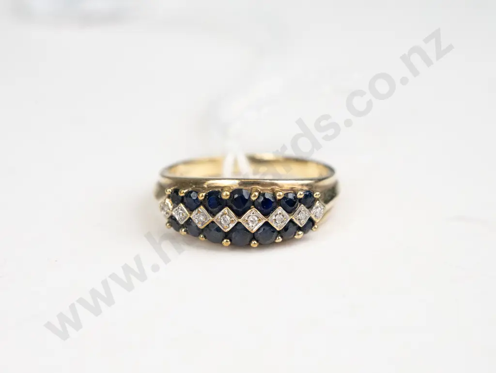 Yellow gold ring with 14 black onyx stones and 8 diamonds set along the top of the ring in three lines Image 1++