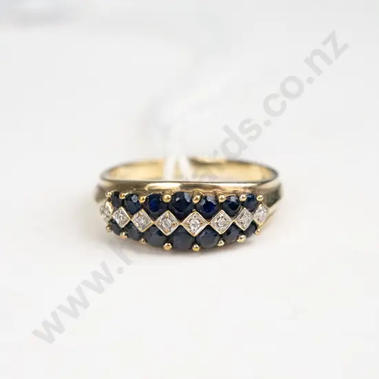 Yellow gold ring with 14 black onyx stones and 8 diamonds set along the top of the ring in three lines