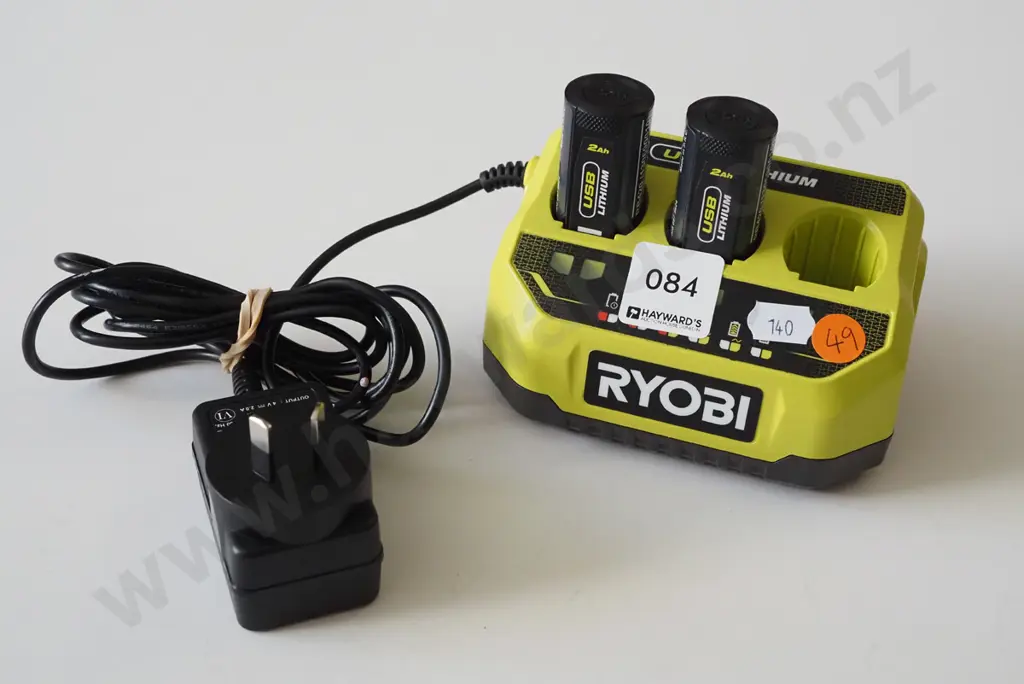 Ryobi black and green battery charging dock with two batteries Image 1++