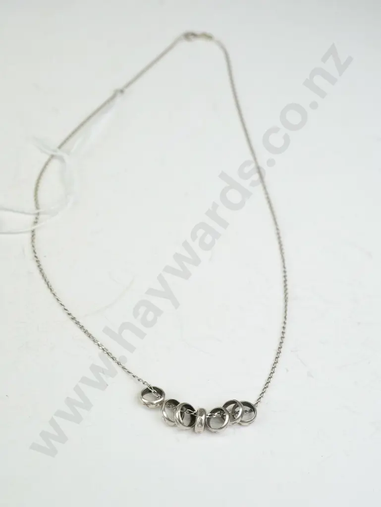 Thin silver necklace with 7 small rings Image 1++
