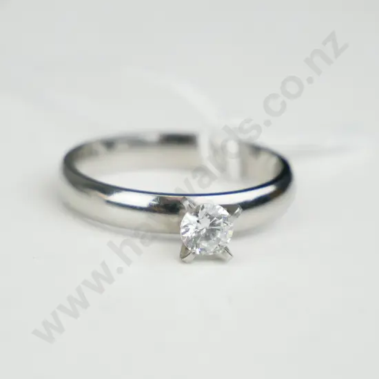 Silver coloured ring with single clear stone