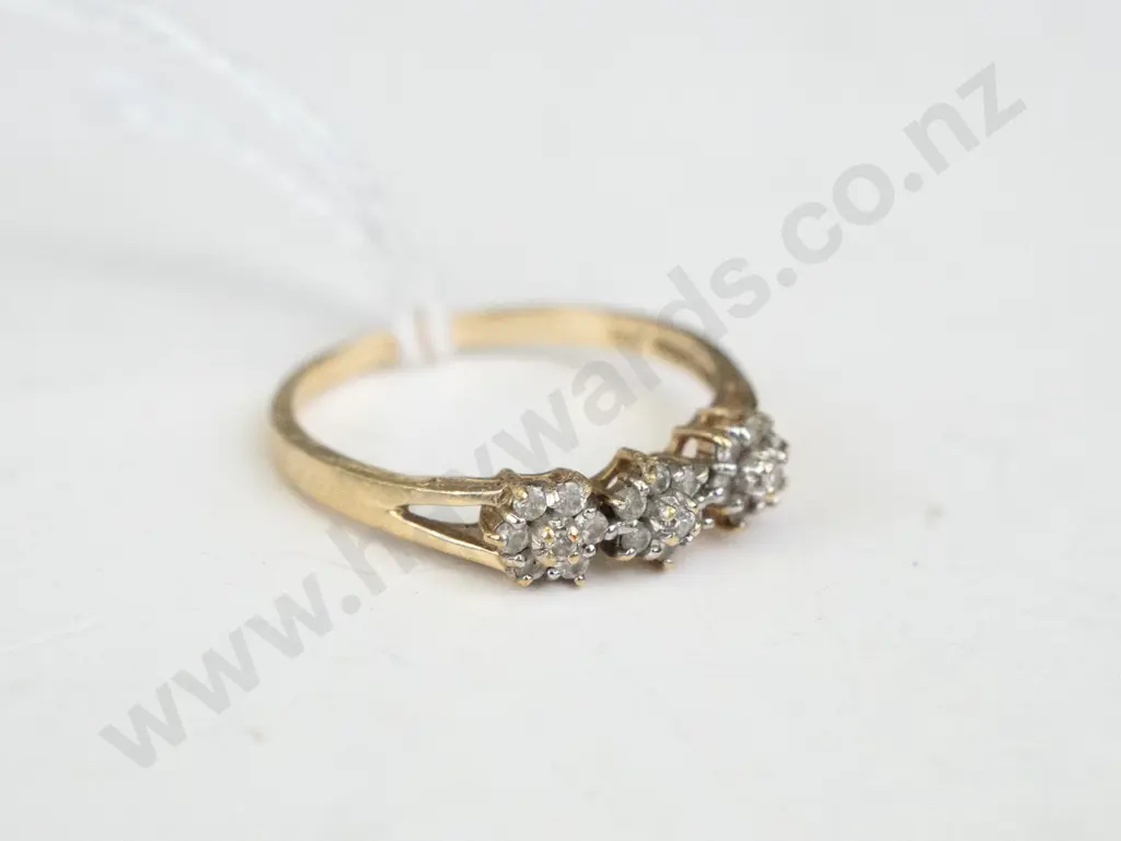 Gold coloured ring with 3 x clusters of white stones on top Image 1++