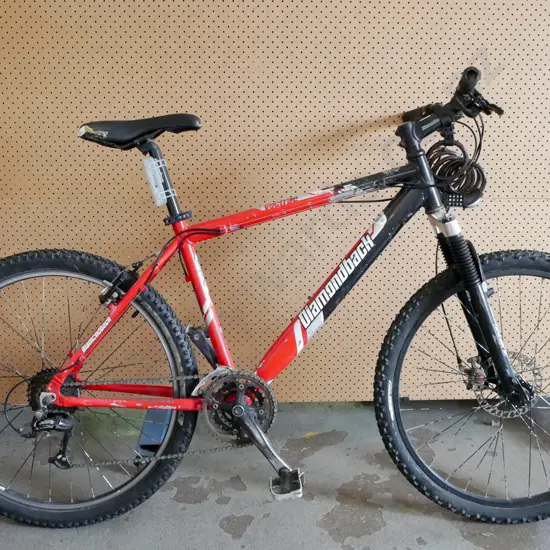 Red and Black Diamondback Bike. Has bike lock and rip in bike seat.