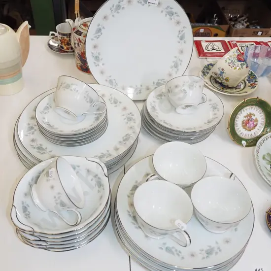 Noritake white and silver rimmed dinner items with floral patterning; plates, cups, bowls etc