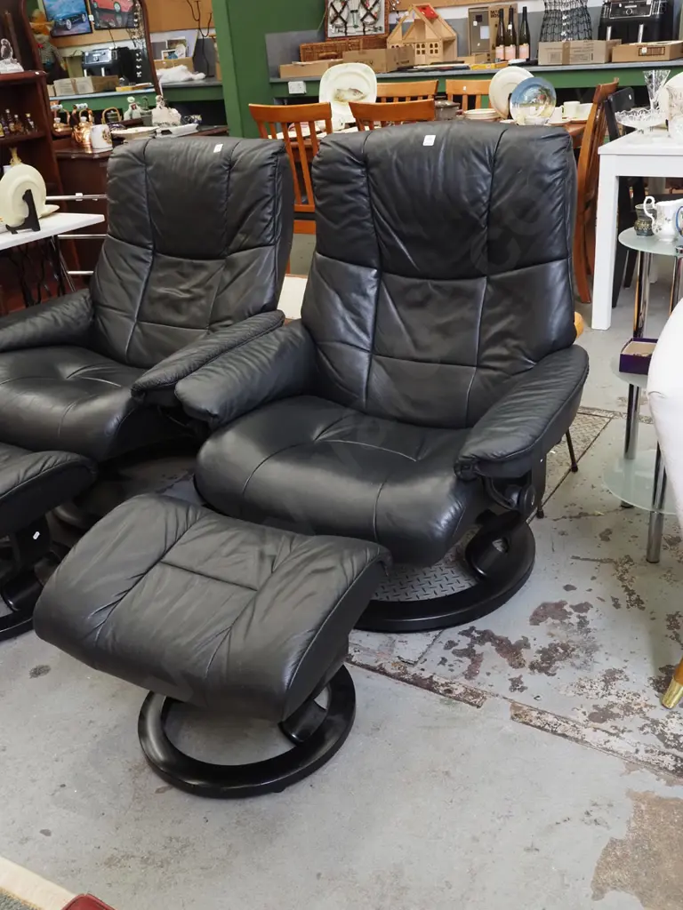 black vinyl Stressless swivel reclining armchair with matching footstool Image 1++