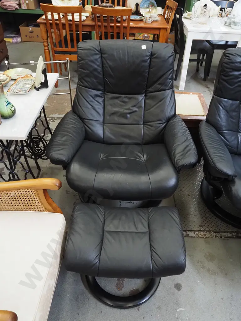 black vinyl Stressless swivel reclining armchair with matching footstool Image 1++