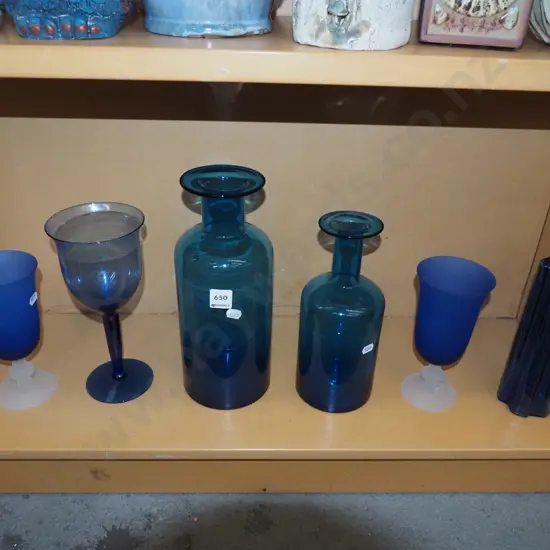 shelf; blue glass bottles, wine glasses