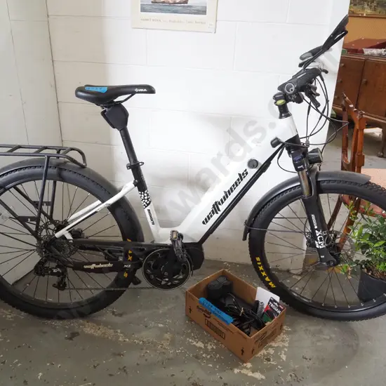 Watt Wheels electric bike with box of accessories including chargers and cables