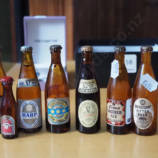 7 miniature beer bottles