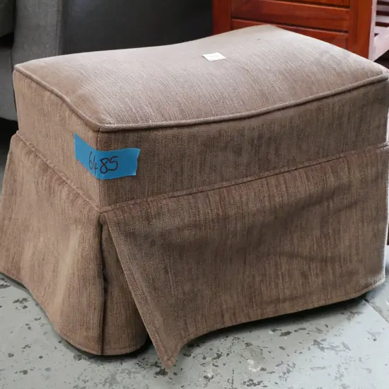 brown upholstered footstool