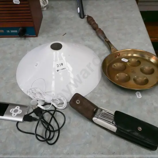 brass frying pan, pocket knife, white glass light shade, small digital music player