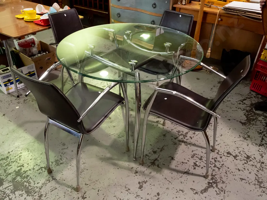 circular chrome based glass top dining table with 4 matching vinyl chairs - glass top table has mahogany Image 1++