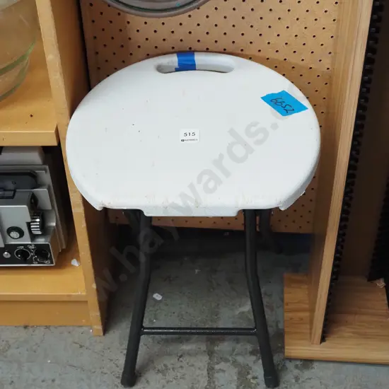 white plastic and metal foldaway stool