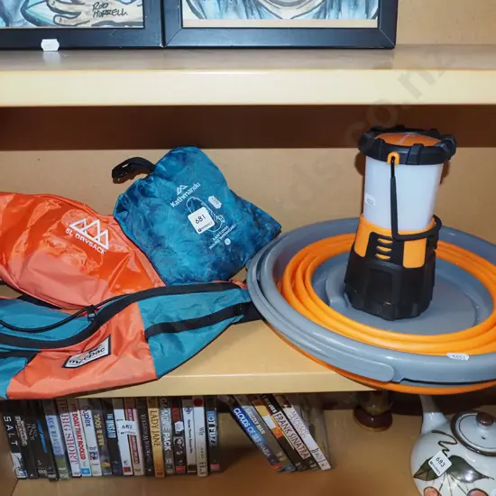 shelf; camping lanterns, collapsable bucket, backpack rain cover etc