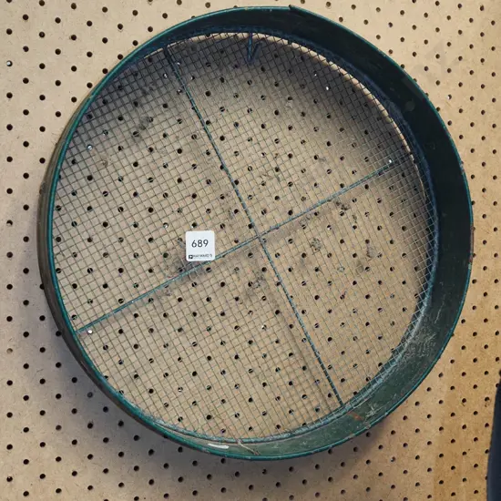 green metal garden sieve