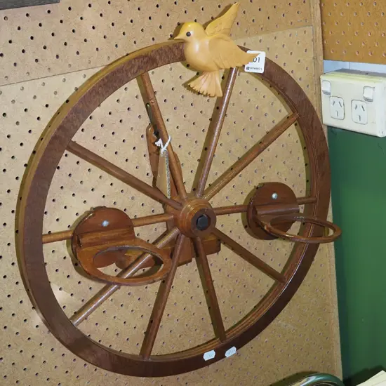wall mounted wooden wheel with carved bird and 2x cup holders