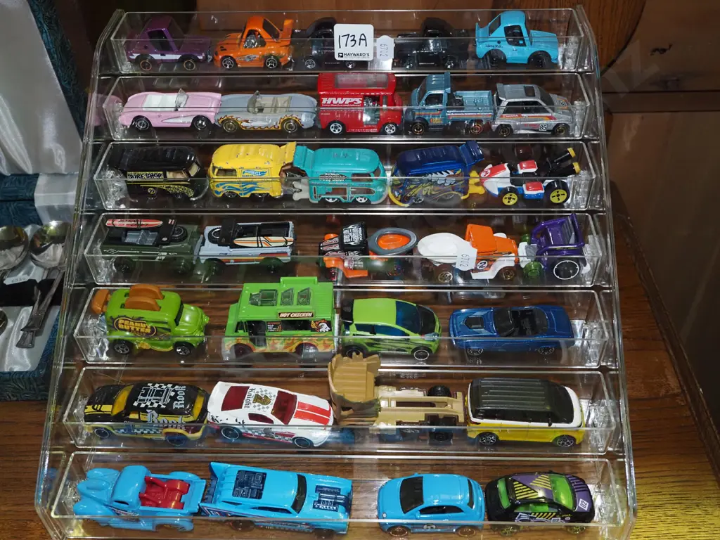 Hotwheels die-cast vehicles in clear plastic display stand Image 1++