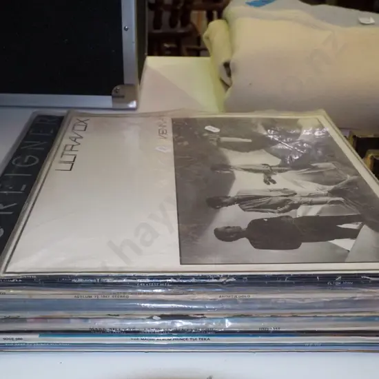 stack of LPs; Foreigner, Ultravox, Elton John etc