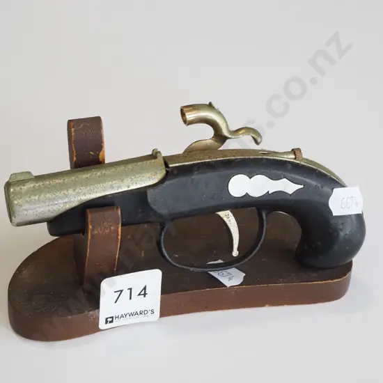 reproduction black powder pistol on stand