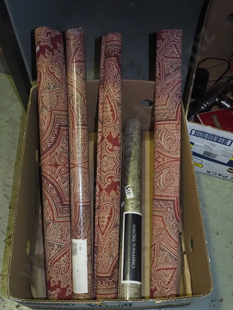 box of various rolls of patterned wallpaper Image 1++
