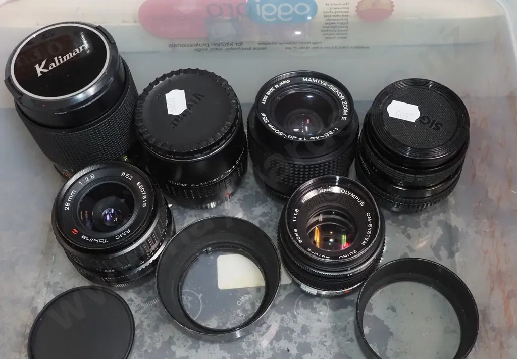 shelf of various camera lenses Image 1++