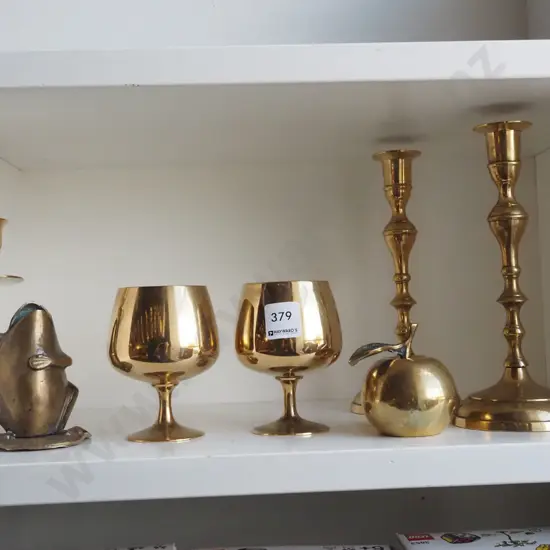brass candlesticks, goblets, apple