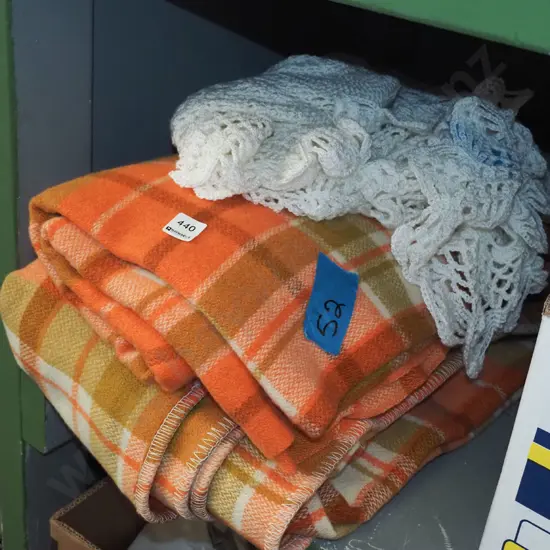 2x orange woollen blankets, 1x crochet shawl blanket