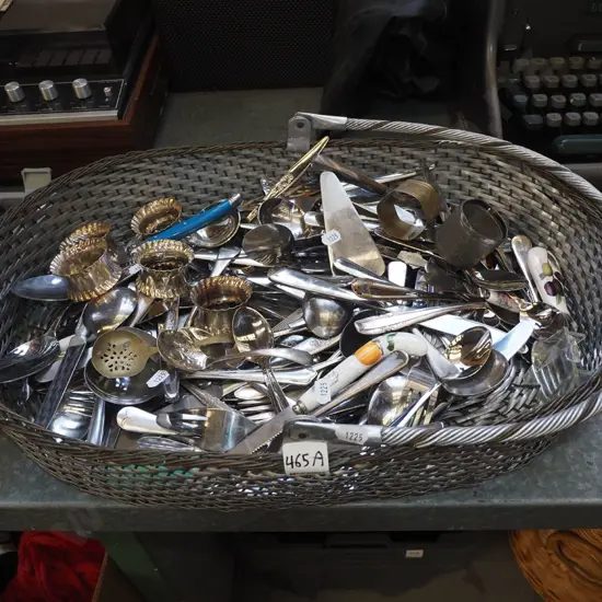 metal basket of cutlery, napkin rings etc