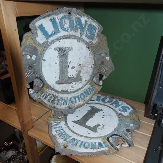 2x Lions International cast alloy signs