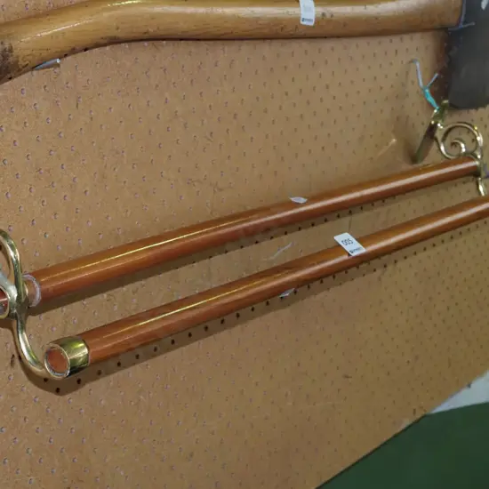 brass and wooden wall mounted towel rail