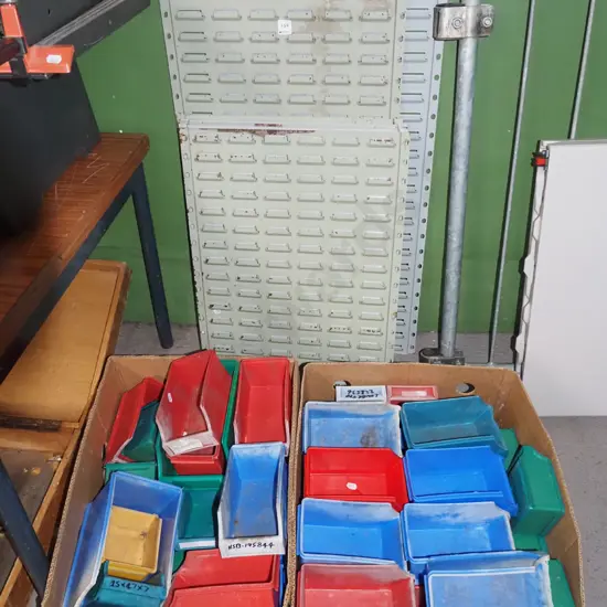 wall mounted louvred storage orgainer with 2x boxes of plastic bins - green dots